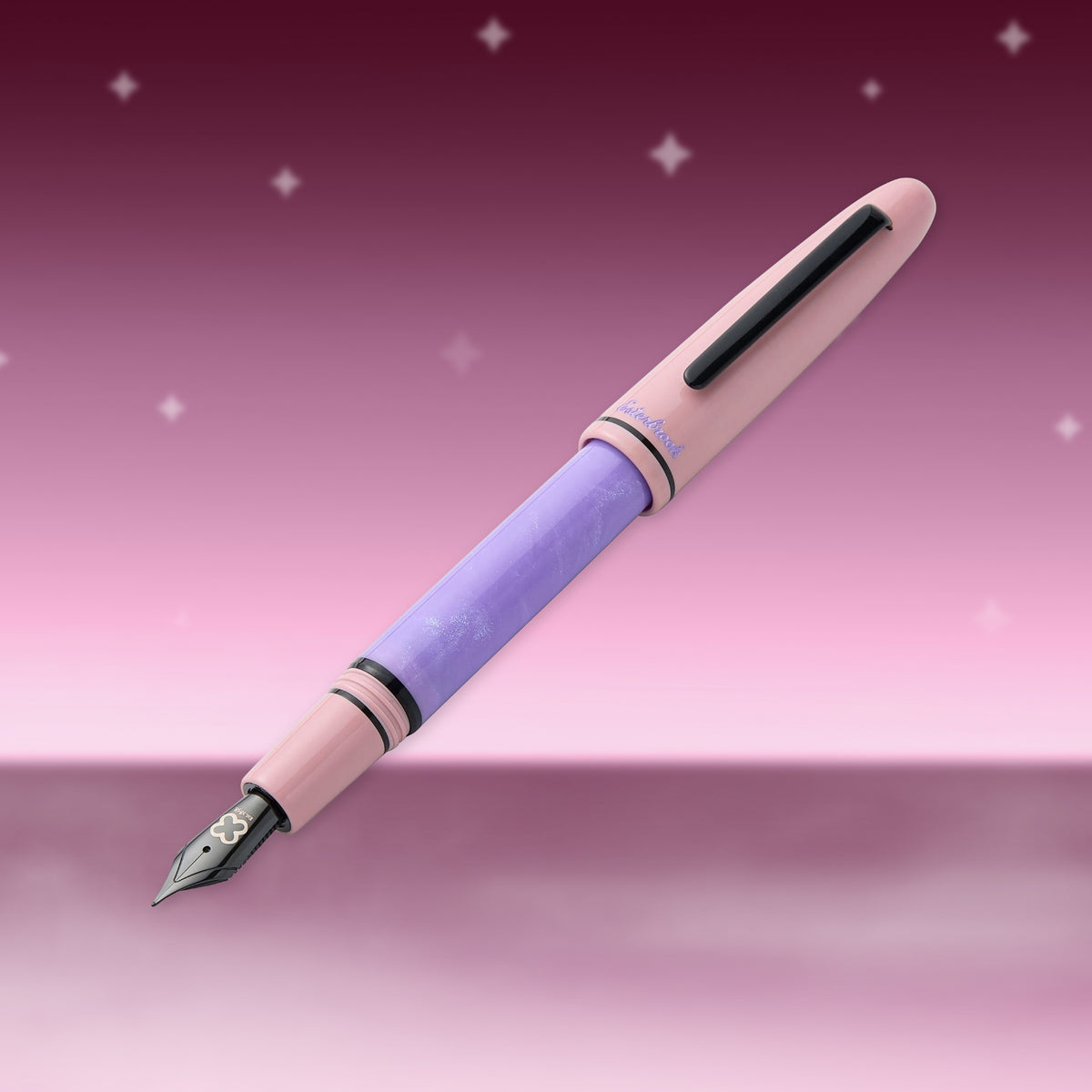 Pastel pink and lavender fountain pen with black nib and clip, close side view