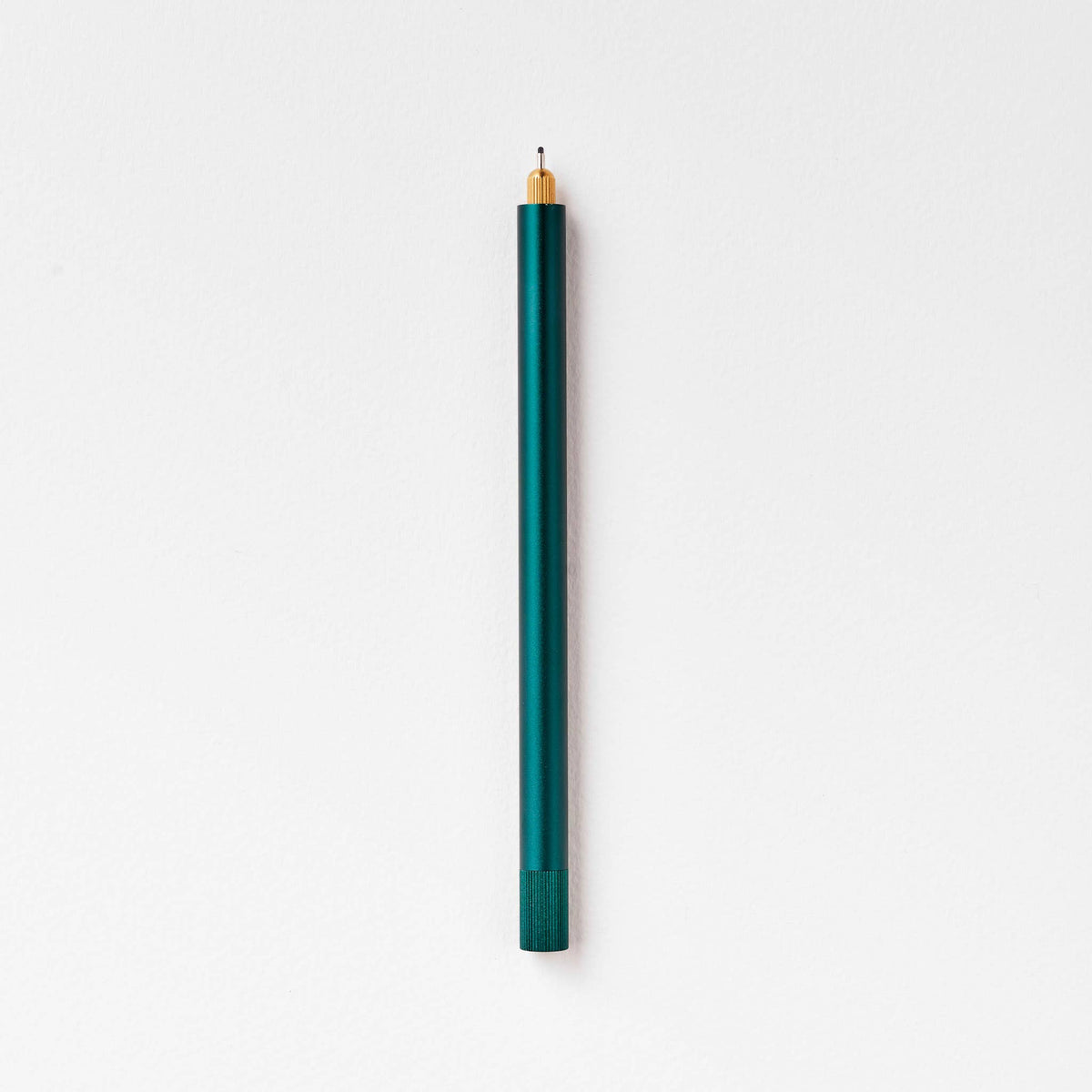 Refillable multi-tip pen with teal barrel and gold nib tip