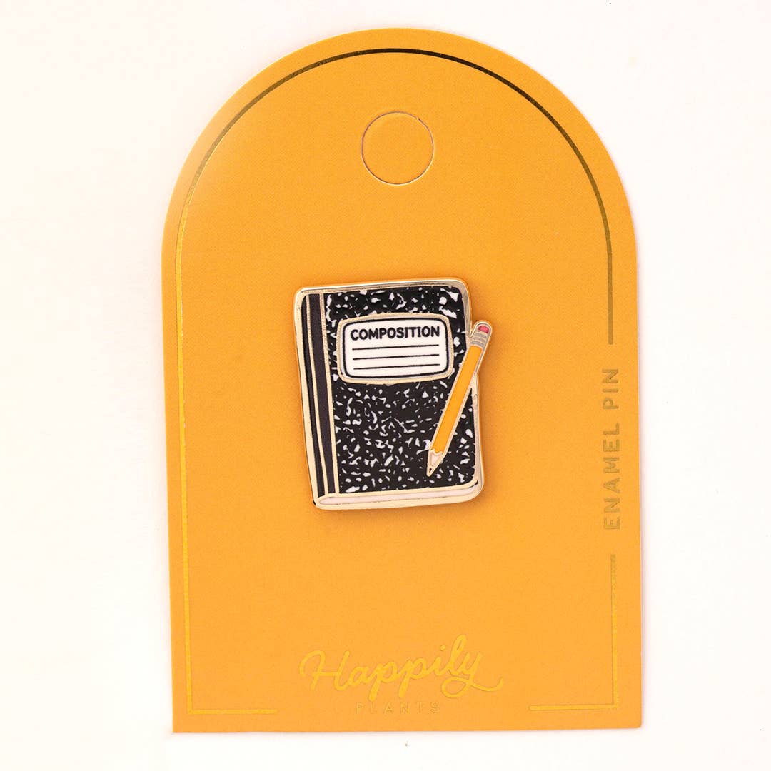 Enamel composition notebook pin on orange arched backing card with 'ENAMEL PIN' text