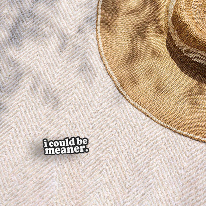 Funny quote sticker reading "i could be meaner." on a beige fabric hat