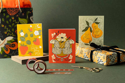 Tiger and floral greeting card displayed with gift wrap and stationery