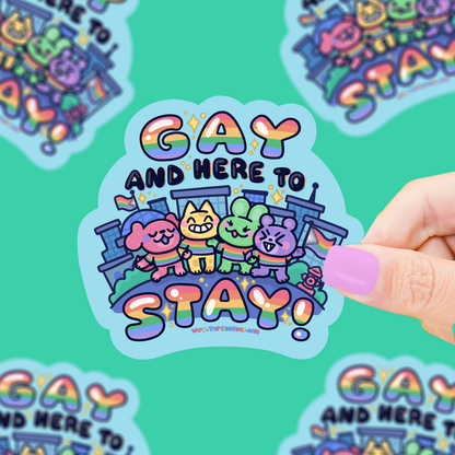 Colorful vinyl sticker with 'Gay and Here to Stay' rainbow lettering and animal figures
