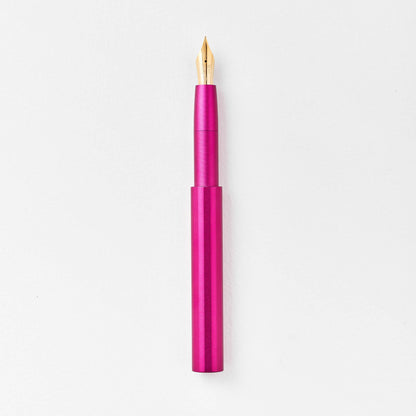 Magenta pocket fountain pen with gold nib, shown uncapped on a white background.