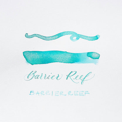Turquoise shimmer ink brush strokes and “Barrier Reef” script lettering on card