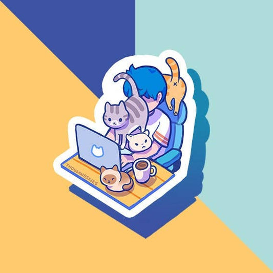 Vinyl sticker of a person working at a desk with two cats and a coffee cup