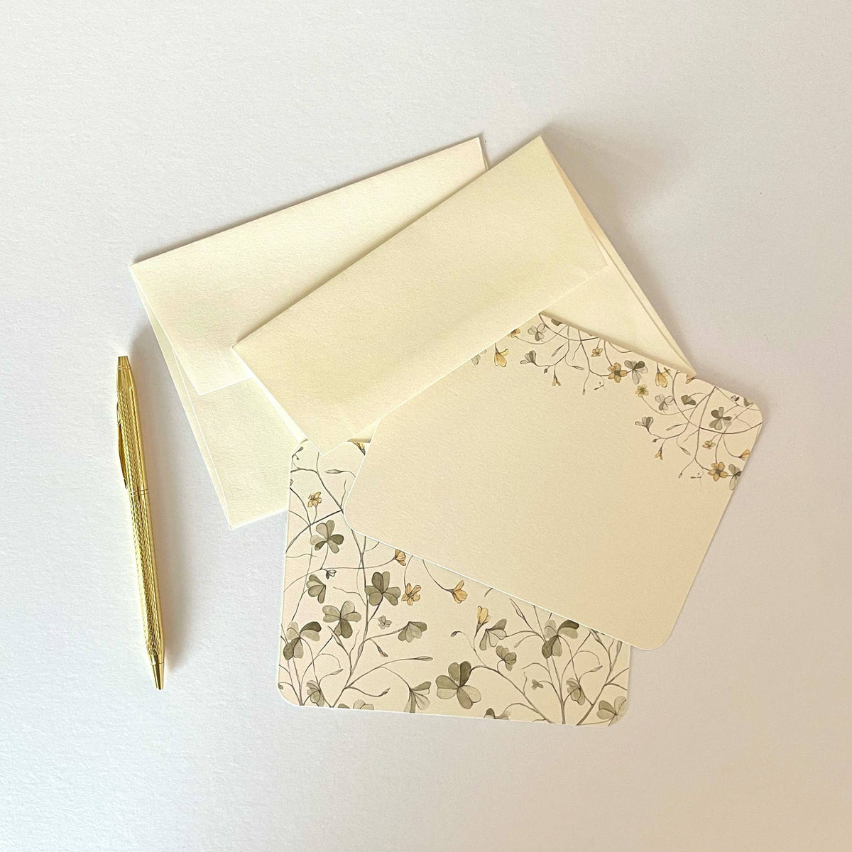 Cream floral stationery envelope set with botanical line art, with matching letter inside