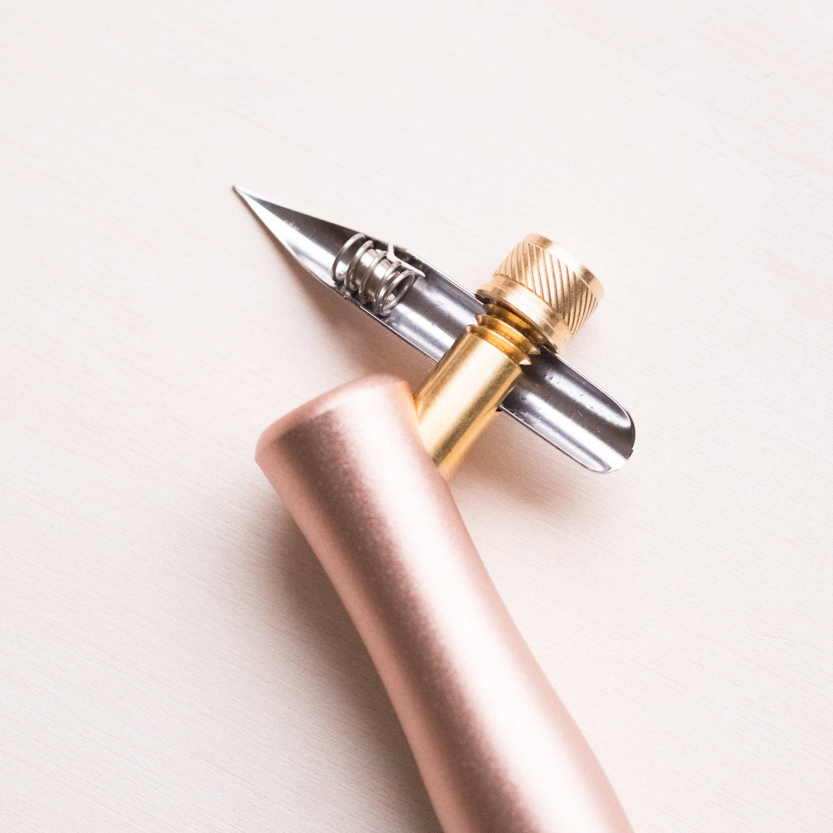 One Dip Wonder applicator pen with rose-gold handle and pointed metal tip