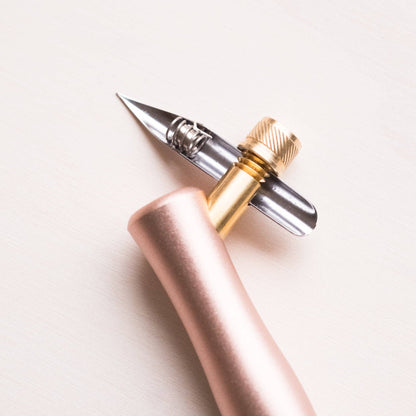 One Dip Wonder applicator pen with rose-gold handle and pointed metal tip