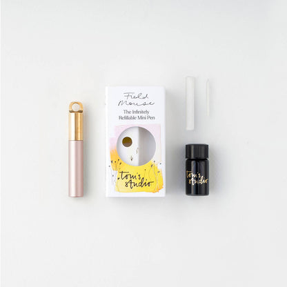 Refillable travel pen set: blush pen with gold clip, plus refill bottle and box