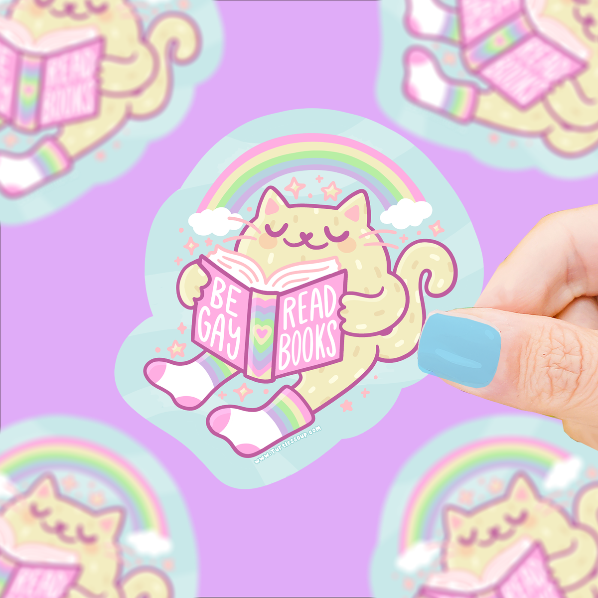 Rainbow cat reading book vinyl sticker with 'Be Gay Read Books' text