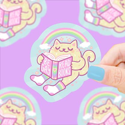 Rainbow cat reading book vinyl sticker with 'Be Gay Read Books' text