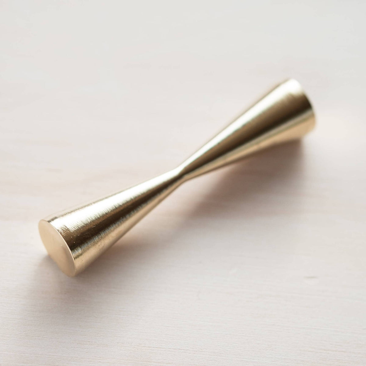 Brass pen rest component with rounded tapered ends, gold metallic finish