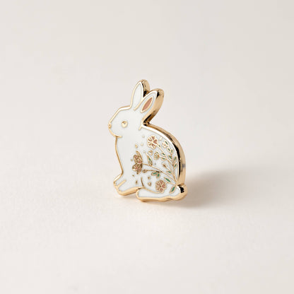Gold-tone rabbit enamel pin with floral garden details, white finish