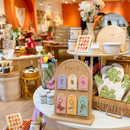 Cherry blossom pin set on a wooden display stand with pink flower cards