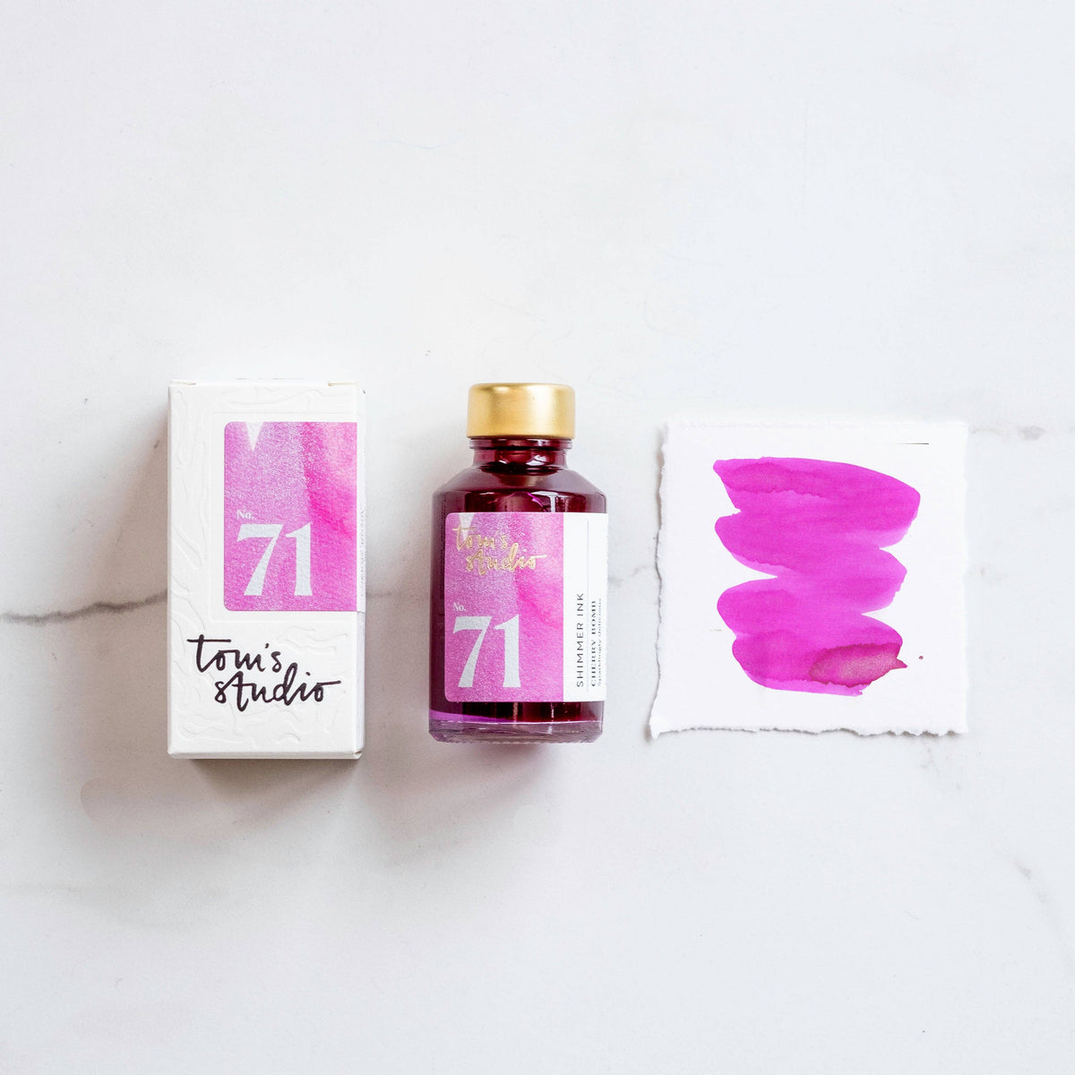 Shimmer ink bottle with packaging and pink glitter swatch, Cherry Bomb shade