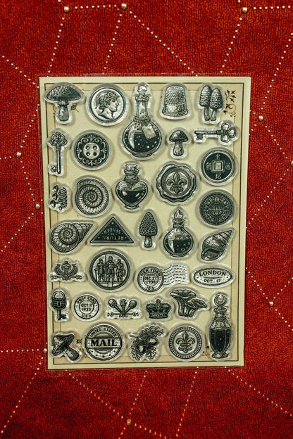 Clear acrylic stamp set with assorted vintage travel and mail symbols, clocks, letters, bottles