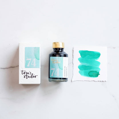 Shimmer ink bottle with turquoise “Barrier Reef” design and matching swatch card