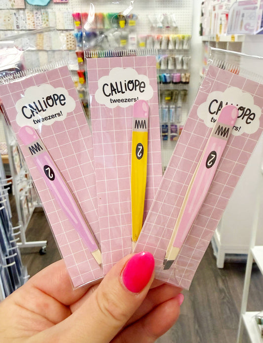 Pencil tweezers for stickers, pink and lilac packs held in hand