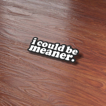 Funny quote sticker reading "i could be meaner." on a wooden table