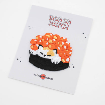 Iron-on cat food patch: cat sleeping on black rice with orange roe topping, embroidered