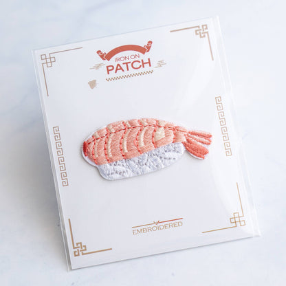 Embroidered salmon sushi iron-on patch on backing card