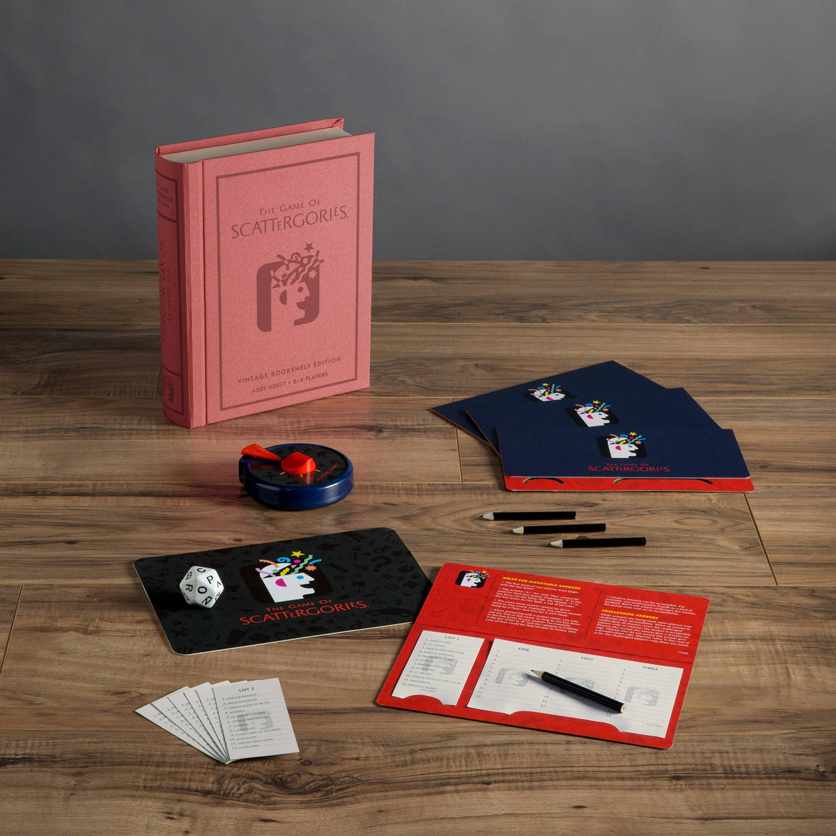 Vintage board game components spread: rule cards, box, dice, and score pad