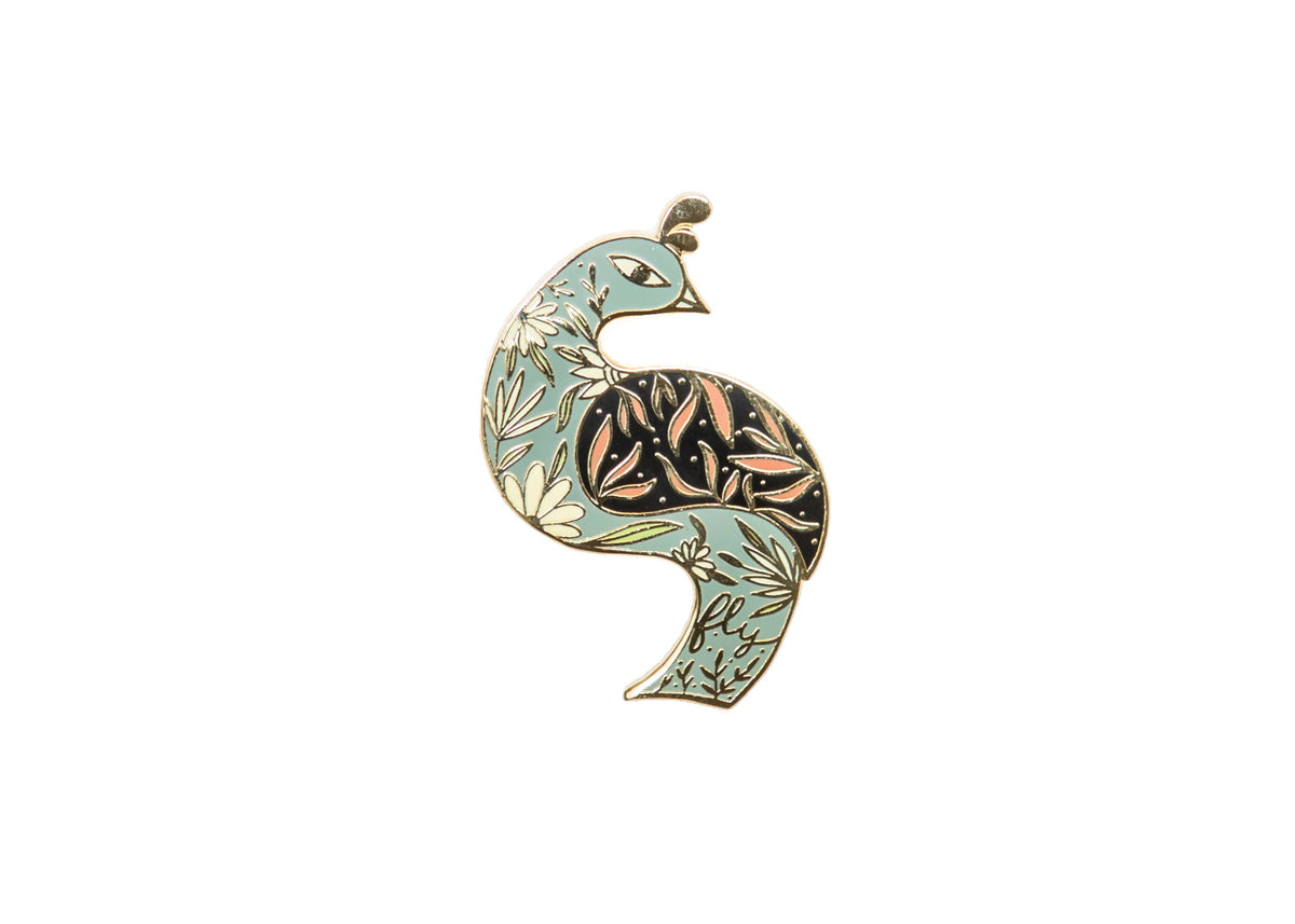 Floral bird enamel pin with pale blue leaves, black patterned feathers, and gold-tone outlines.