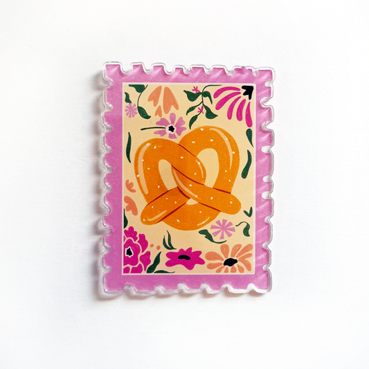 Square acrylic magnet with pink scalloped border and orange pretzel floral stamp art