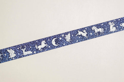 Washi tape strip in navy blue with white unicorn, moon, and star motifs