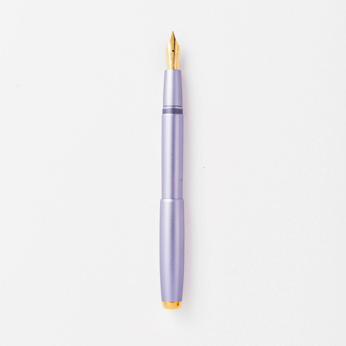 Lilac fountain pen with gold nib and clip, shown upright.