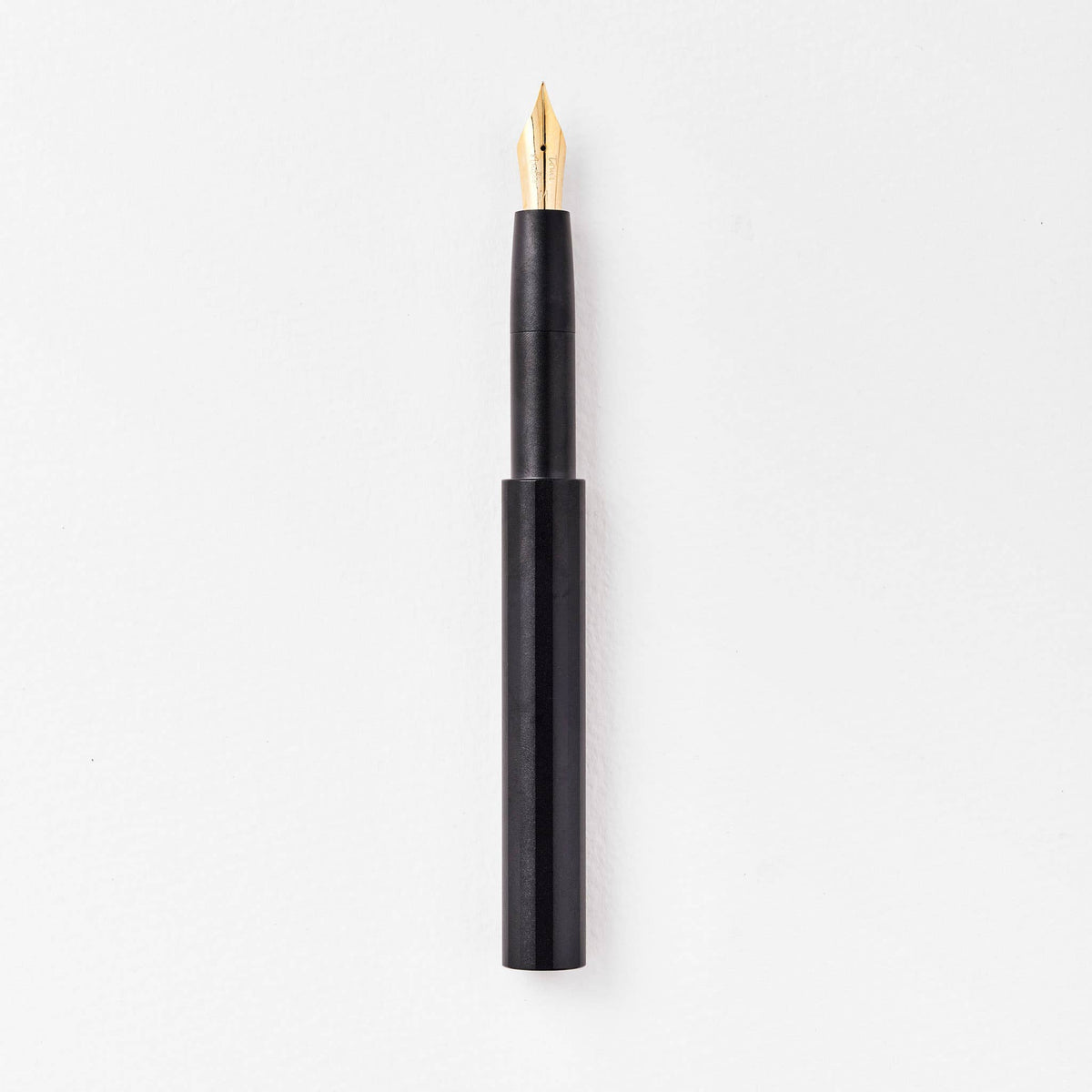 Dark fountain pen with gold nib and matte black body