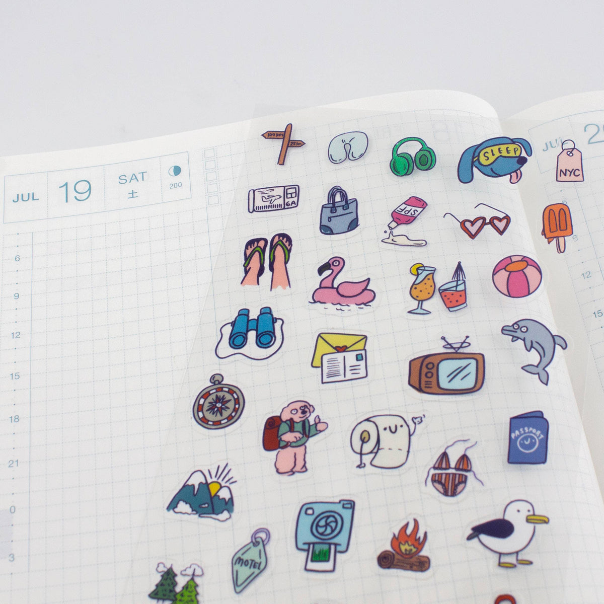 Clear planner sticker sheet laid flat with numbered calendar page and matching icons