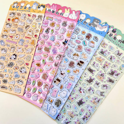 Pastel sticker set with cartoon cat and bunny designs, icons, and shiny holographic accents.