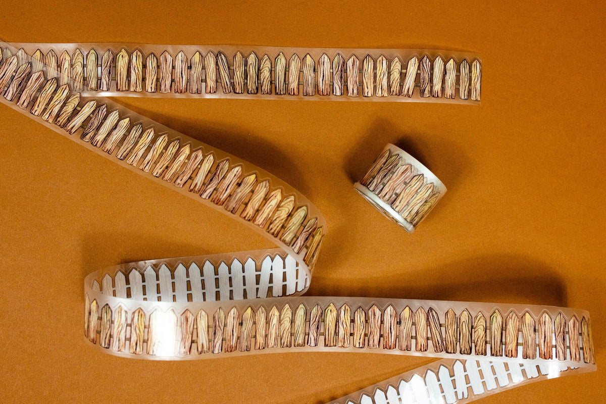 Transparent wooden fence tape strips and small roll with brown bristle-like edges