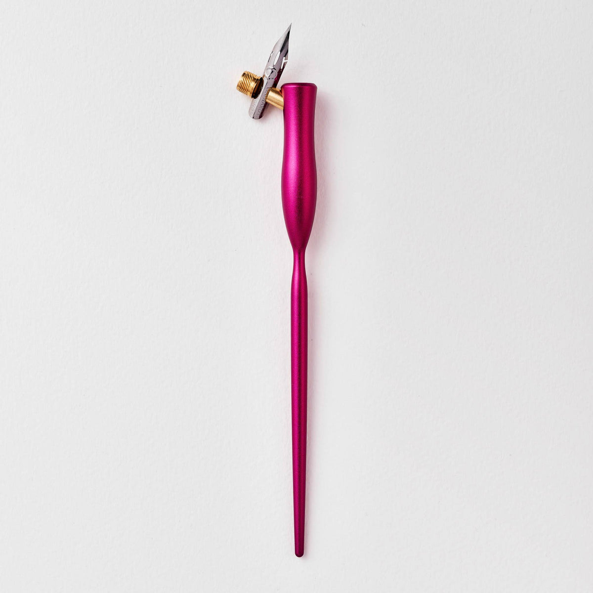 Pink flourish calligraphy pen with angled nib and gold accent ring