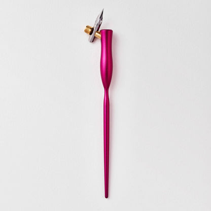 Pink flourish calligraphy pen with angled nib and gold accent ring