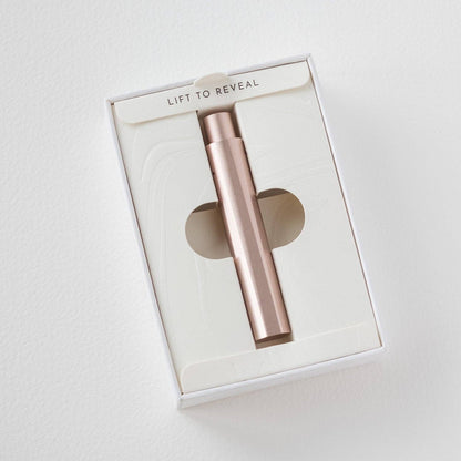 Refillable writing pen in gift box, rose-gold barrel visible through window