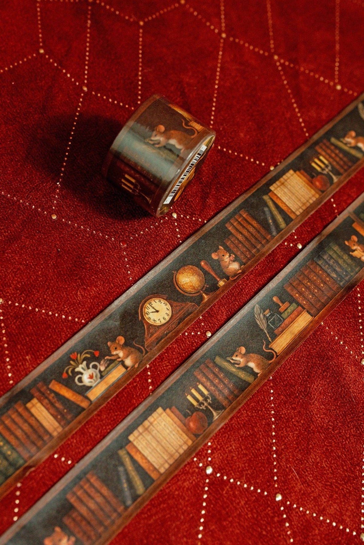 Washi tape strip with antique books, globe, and clock motifs and partial roll