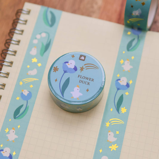 Blue washi tape strip and roll with duck, flowers, and sparkles