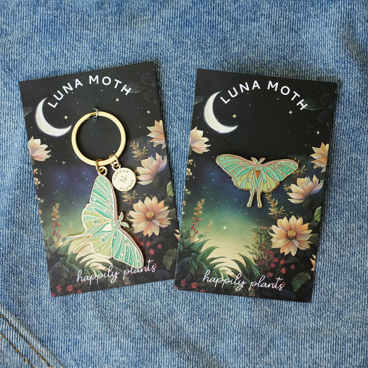 Luna moth keychain/pendant cards on denim, showing gold hoop and illustrated moth
