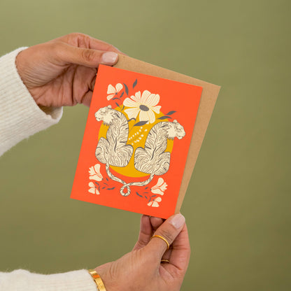 Greeting card featuring mirrored tigers and flowers on a coral cover