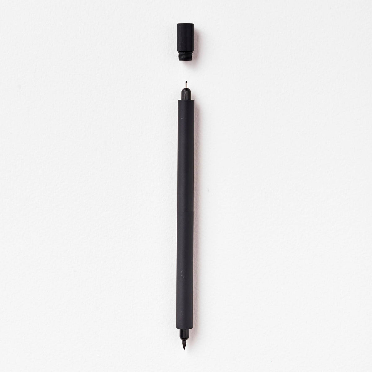 Matte black refillable multi-tip pen, capped, with visible writing tip