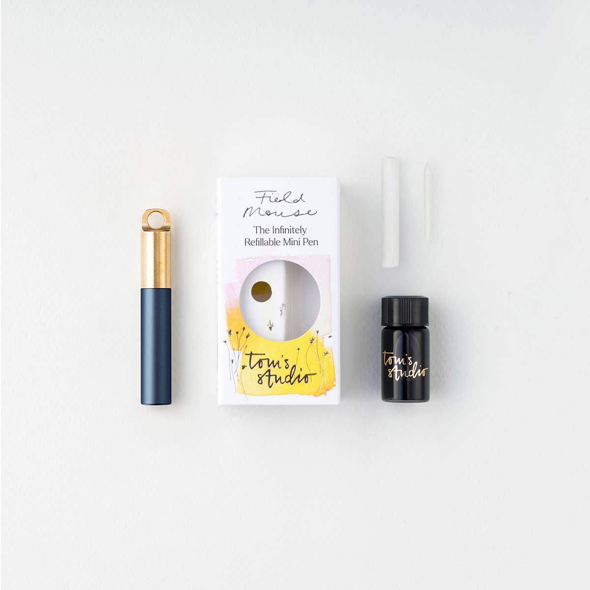 Refillable travel pen set: navy pen with gold clip, plus refill bottle and box