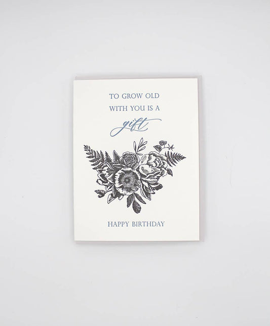 Birthday card, white with black floral bouquet and “Happy Birthday” text