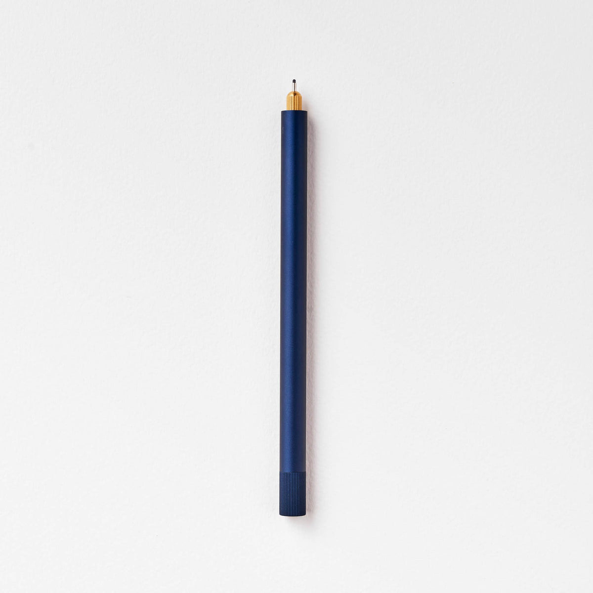 Midnight blue refillable multi-tip pen with capped end and gold writing tip