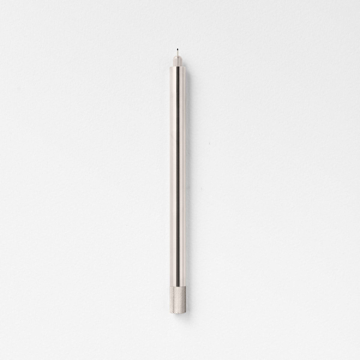 Stainless steel fountain pen, side view, with textured grip and single tip