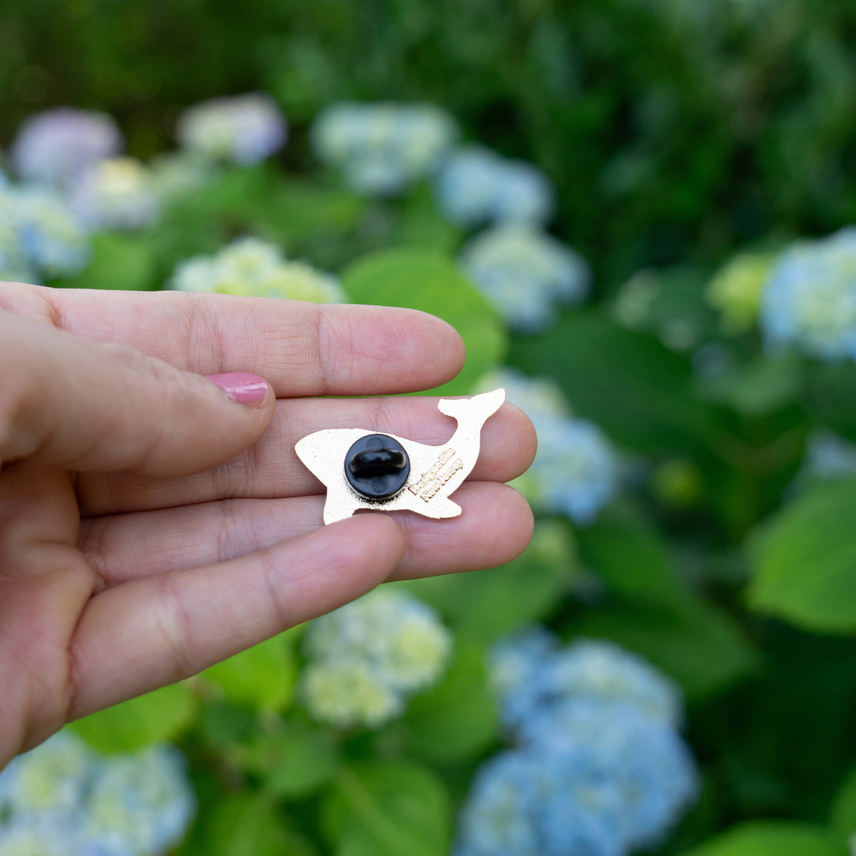 Back of whale enamel pin with butterfly clasp and round backing