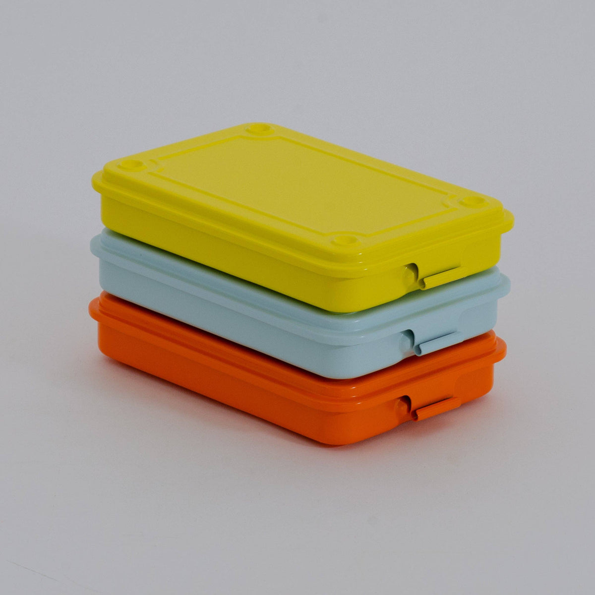 Three Toyo steel storage boxes stacked in yellow, pale blue, and orange