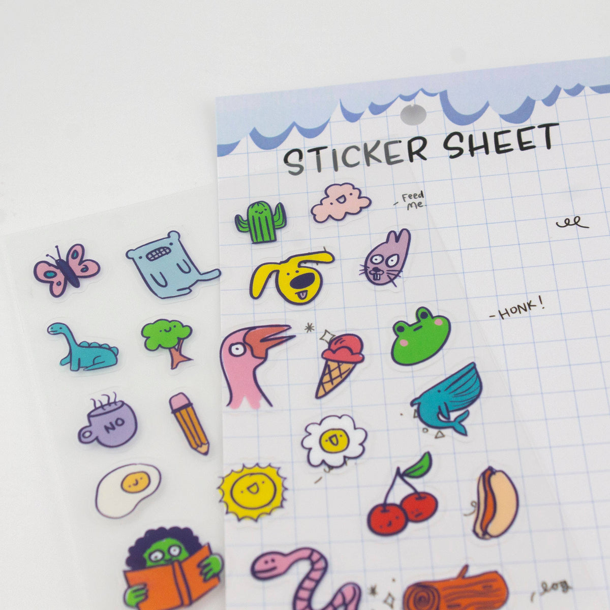 Clear sticker sheet featuring colorful doodle stickers, including animals, fruit, and “HONK!”
