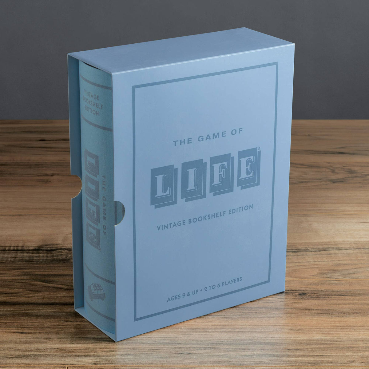 Light blue bookshelf game box with The Game of Life Life logo on front